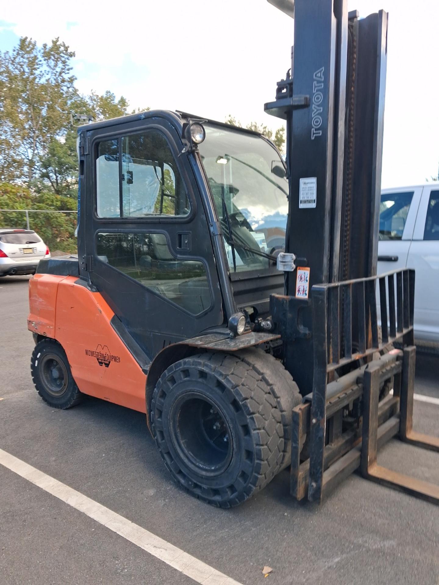 Forklift parked in a lot, shown from the front three-quarter view